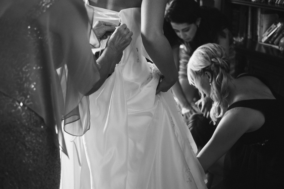 Bride Putting Dress On